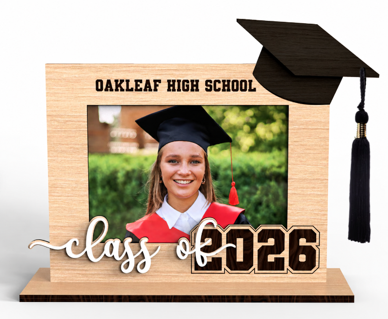 Wooden graduation photo frame with personalized school name, class of 2026 lettering, and black graduation cap on white background