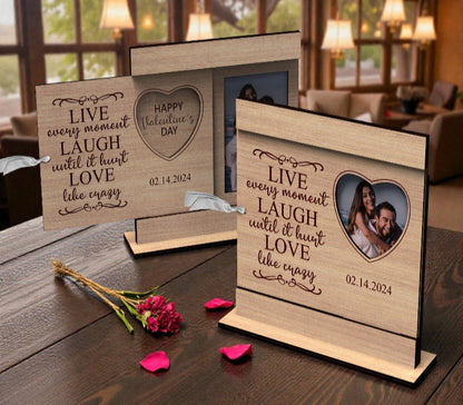 Personalized Valentine’s Day wooden photo frame with engraved love quote, heart-shaped photo opening, and tabletop stand, displayed with a couple’s photo.