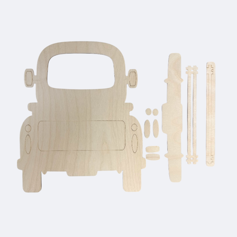 A wooden DIY interchangeable farmhouse truck base with various parts laid out, including a slotted base, side panels, and a sign post file.