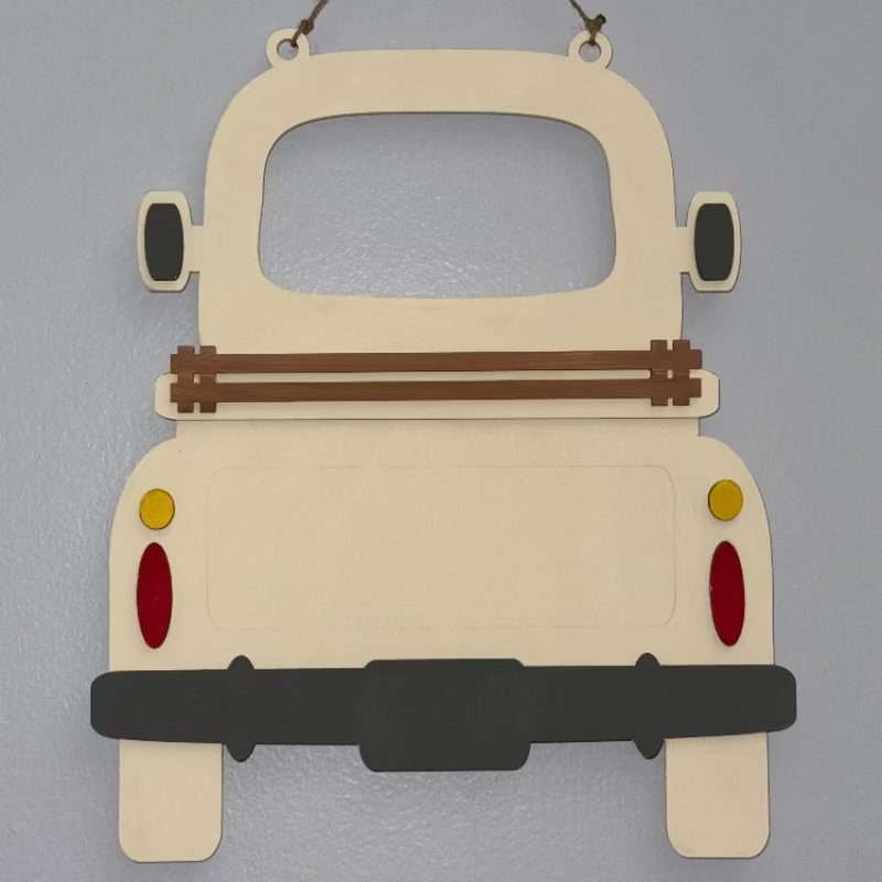 A wooden DIY farmhouse truck base with a slotted base and decorative elements on the back panel, designed for seasonal inserts.