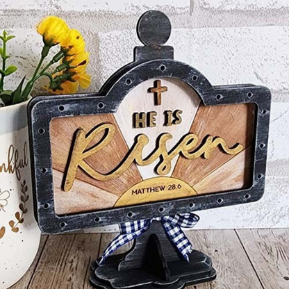 Hand-painted He Is Risen interchangeable mini stand insert featuring cross and Matthew 28:6 Bible verse displayed on black wooden tabletop stand by Jazzi’s Creations