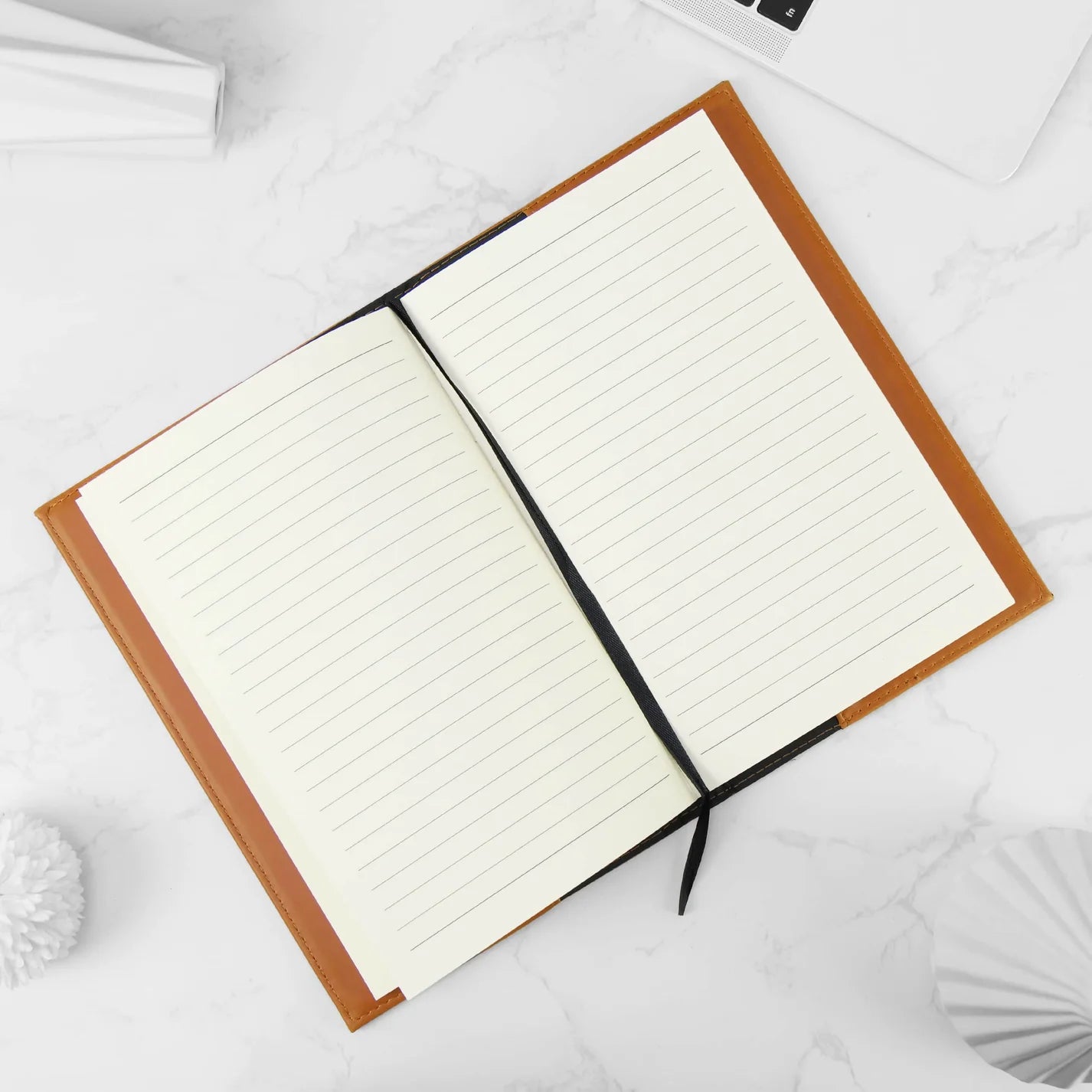 Open notebook with lined pages on a white surface