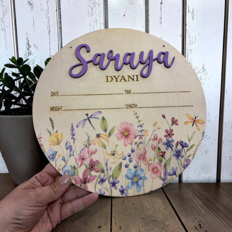 Jazzi's Creations personalized 10-inch floral baby birth announcement sign made from Baltic Birch with UV printing, laser engraving, raised 3D name lettering, and customizable birth statistics.