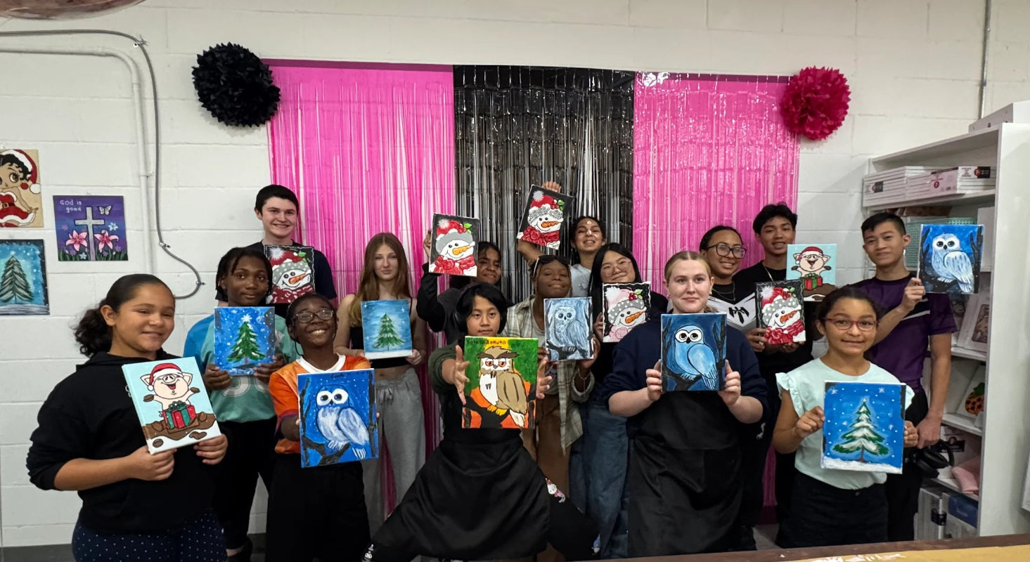 Group of children holding up their artwork at jazzis creations