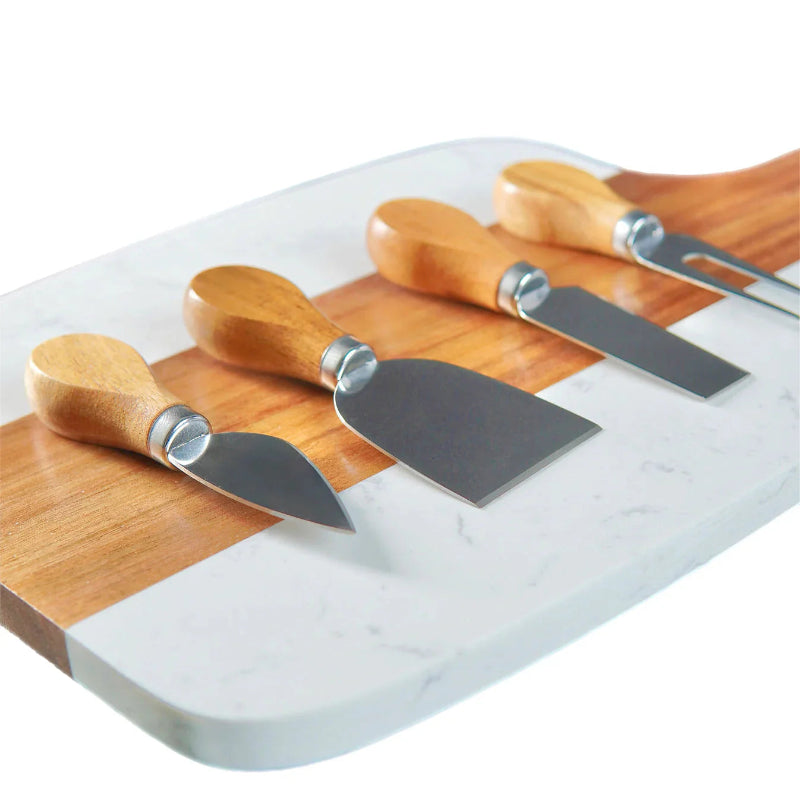 Set of four cheese knives with wooden handles on a marble cutting board at jazzis creations in orange park fl