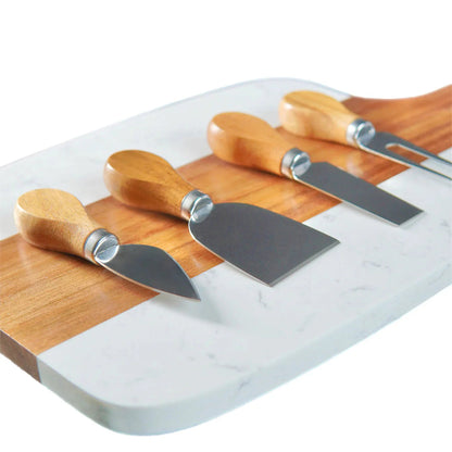 Set of four cheese knives with wooden handles on a marble cutting board at jazzis creations in orange park fl