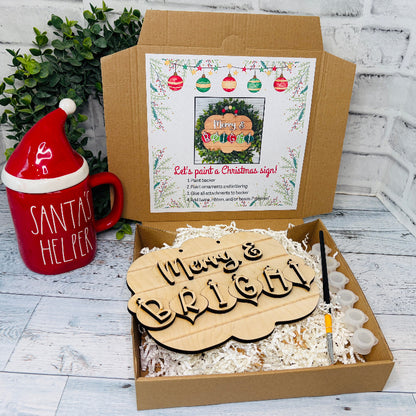 Christmas-themed gift set with wooden sign, mug, and festive decor on a white wooden surface craft kit at jazzis creations in orange park fl