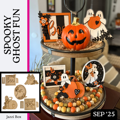 Halloween-themed decor set with pumpkins, ghosts, and decorative items on a tiered stand.