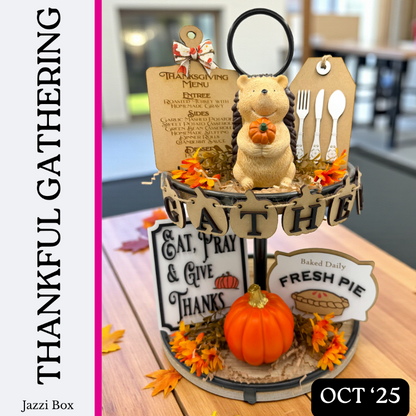 Decorative Thanksgiving display with a bear figurine, pumpkins, and autumn leaves on a wooden table.