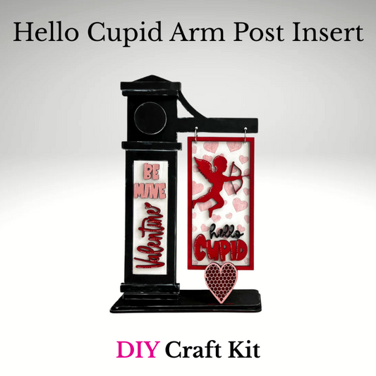 Valentine interchangeable arm post insert featuring a red Cupid with bow, heart background, and “Hello Cupid” text in a red frame, displayed on a black arm post stand.