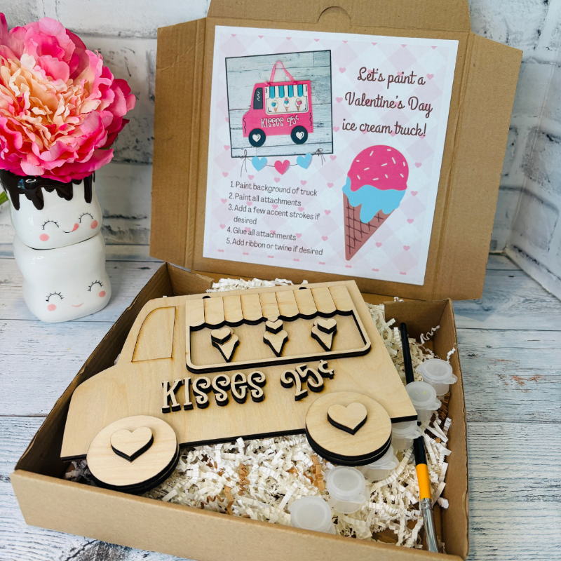 Wooden ice cream truck kit in a box with paint supplies and a pink flower on a wooden surface diy craft kit at jazzis creations in orange park fl