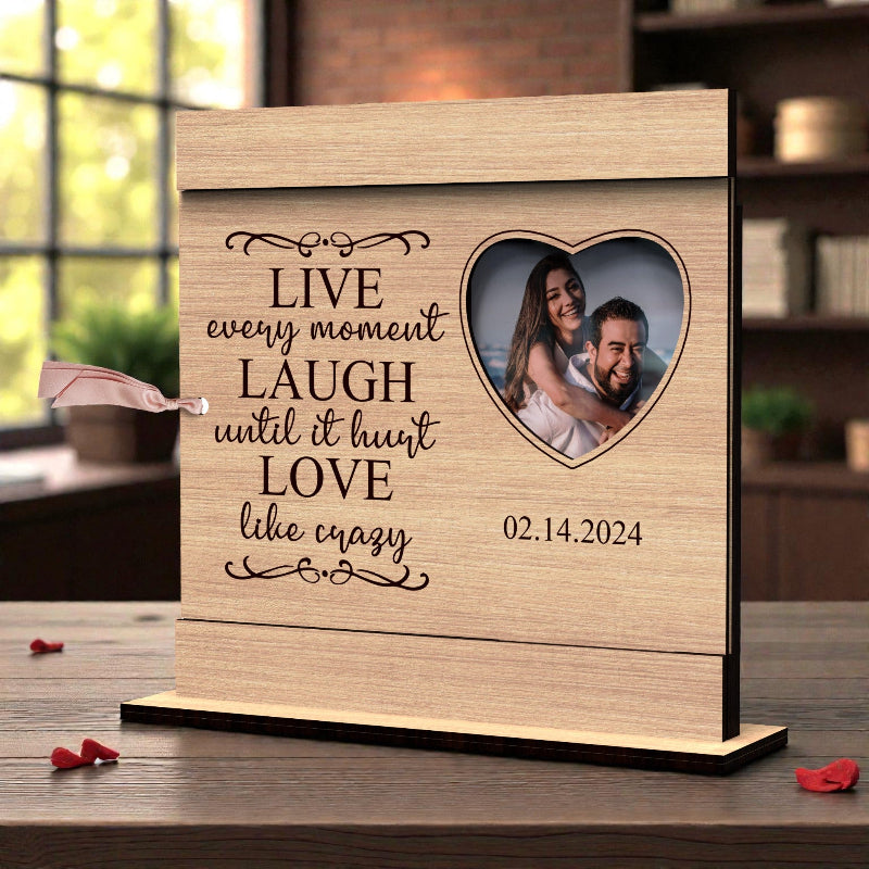 Personalized Valentine’s Day wooden photo frame with engraved love quote, heart-shaped photo opening, and tabletop stand, displayed with a couple’s photo.