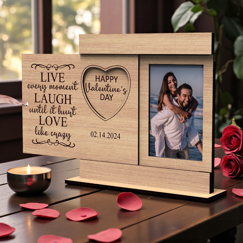 Personalized Valentine’s Day wooden photo frame with engraved love quote, heart-shaped photo opening, and tabletop stand, displayed with a couple’s photo.