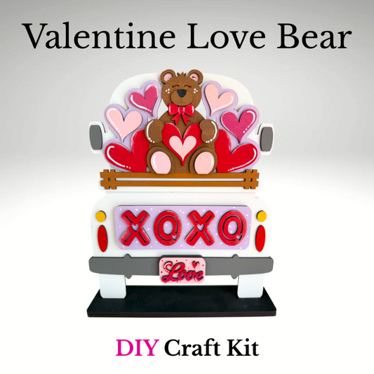 Valentine-themed bear craft kit with hearts and 'XOXO' text on a white background