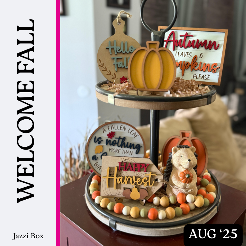 Decorative tiered stand with fall-themed signs and pumpkins on a blurred background.